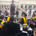 A Spanish tuna serenades a student in the Plaza Mayor in Salamanca