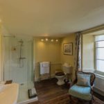 One of the Manor bathrooms with shower and bath at Trebinshun House
