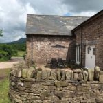 Outside courtyard and driveway of the Honeysuckle Cottage
