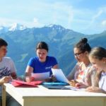 Altitude language summer camp campers have lessons outside