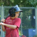 Camp Twin Creeks camper plays baseball