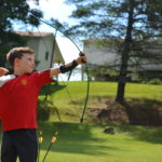 Camp Twin Creeks camper has an archery lesson