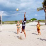Rennert Miami Plus! students play beach volleyball