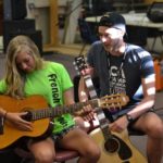 French Woods campers have a guitar lesson