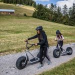 Leysin American School Summer Camp students ride scooters