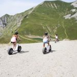 Alpadia Leysin Summer Camp students ride scooters