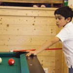 Alpadia Leysin Summer Camp students play pool