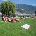 Alpadia Montreux French Summer Camp students relax on the shores of Lake Geneva