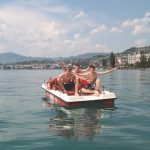 Alpadia Montreux French Summer Camp students go paddleboating on Lake Geneva