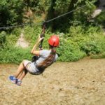 Alphabet Outdoor Exploration Camp students go ziplining