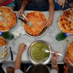Gli studenti degli Alphabet City Camp mangiano una pizza di sera