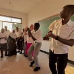 Recoding Africa director dancing with Ghomme Secondary School students