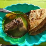 Breakfast with tortilla and stewed fish on the beach