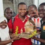 High school students work in small groups on a Found Object Collage activity
