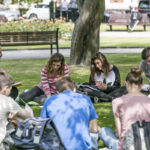 Students at CES Leeds have class outside on a nice day
