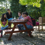 Students in the Cambridge Academy of English garden