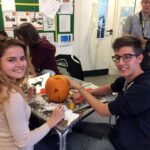 Excel English students carve pumpkins for Halloween