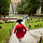 An actor gives a tour of Granary Burial Ground in Boston