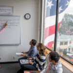 NESE Boston students in class with view of Cambridge