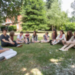 Students have class on the lawn at Richmond, the American University