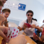 Card game in the Studio Cambridge cafeteria