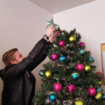 An FLS New York student decorates the school Christmas tree
