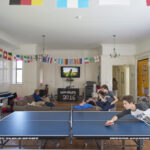 Students play ping pong in one of the common rooms