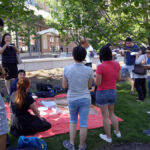 FLS International New York students eat pizza on the campus lawn