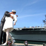 The Unconditional Surrender statue with the USS Midway Aircraft Carrier Museum in the background.