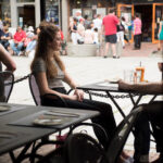 An FLS Boston student at a café