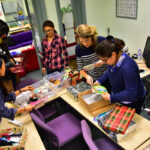 Students prepare gift boxes at Christmas for charity
