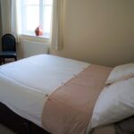 Double bed in a Globe English Centre apartment