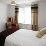 A bedroom in the Cedar Cottage Apartments
