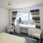 A bedroom in the Rosa Executive Apartments with a view of the sea