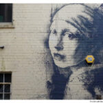 Banksy's "Girl with the Pearl Earring" street art in Bristol